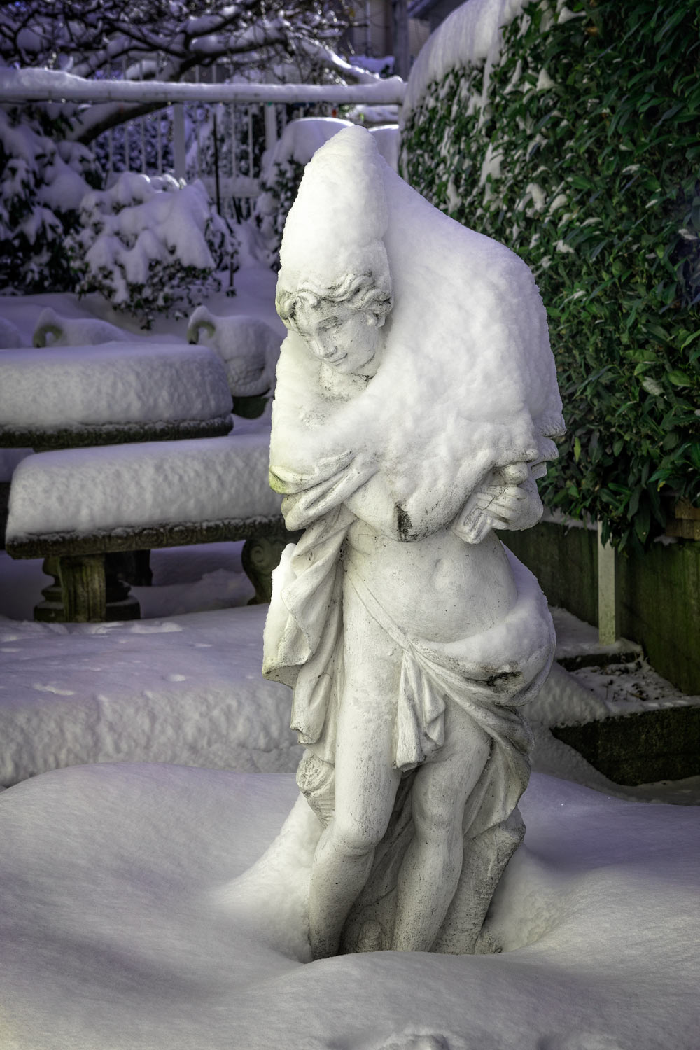 Statue of a lAdy in the Garden heaped with Snow.
